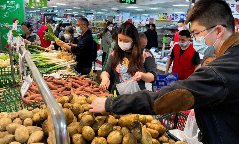 Customers shop at a supermarket in Beijing